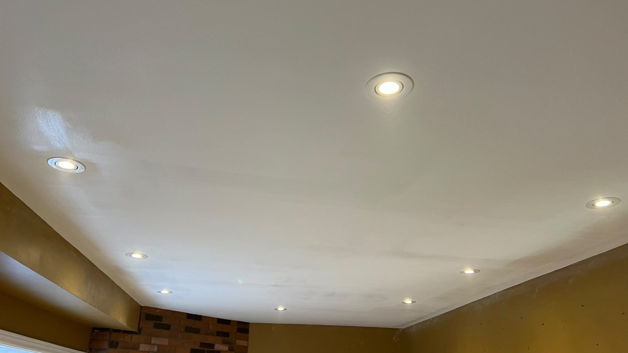After: repaired smooth ceiling with the popcorn texture removed